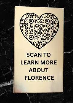 Black memorial plaque with a heart-shaped QR code reading Scan to learn more about Florence